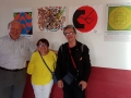 Jacques, Martine Penard et Bertrand devant les dessins des personnes handi de ARIMC et Berthau